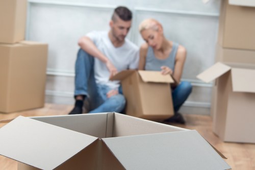 People managing belongings during a move with Addiscombe storage support