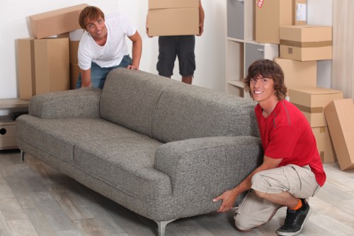 Professional movers handling boxes during a small removals job
